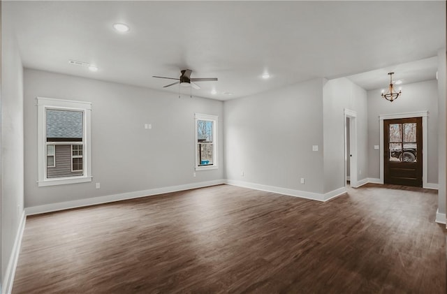 9 Beaty Ln, Bella Vista, AR 72715 - unfurnished living room featuring dark wood-type flooring, baseboards, recessed lighting, and a healthy amount of sunlight