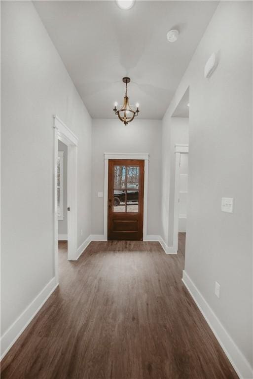 9 Beaty Ln, Bella Vista, AR 72715 - entrance foyer featuring a chandelier, baseboards, and dark wood finished floors