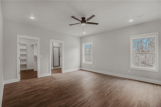 9 Beaty Ln, Bella Vista, AR 72715 - unfurnished bedroom with dark wood-type flooring, a spacious closet, visible vents, recessed lighting, and baseboards
