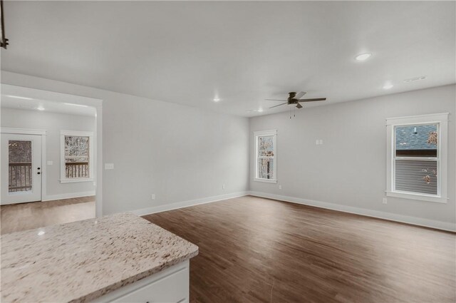 9 Beaty Ln, Bella Vista, AR 72715 - unfurnished living room featuring dark wood-style flooring, ceiling fan, recessed lighting, and baseboards