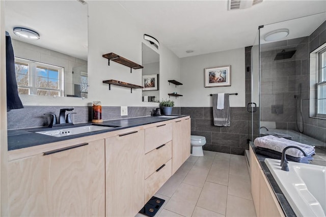 11300 Spring Mountain Dr, Farmington, AR 72730 - full bathroom with tile walls, toilet, a shower stall, a sink, and visible vents