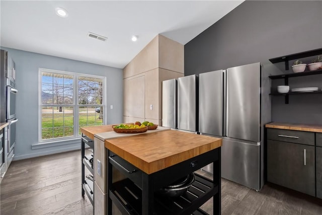11300 Spring Mountain Dr, Farmington, AR 72730 - kitchen with open shelves, wood finished floors, appliances with stainless steel finishes, butcher block counters, and visible vents