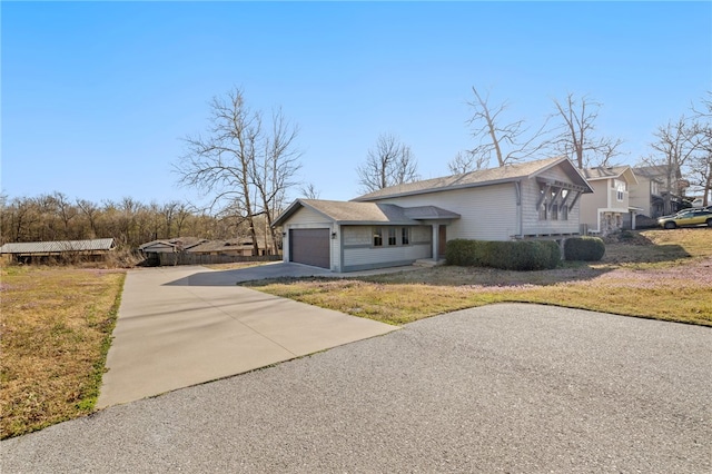 view of property exterior with a lawn, driveway, and a garage