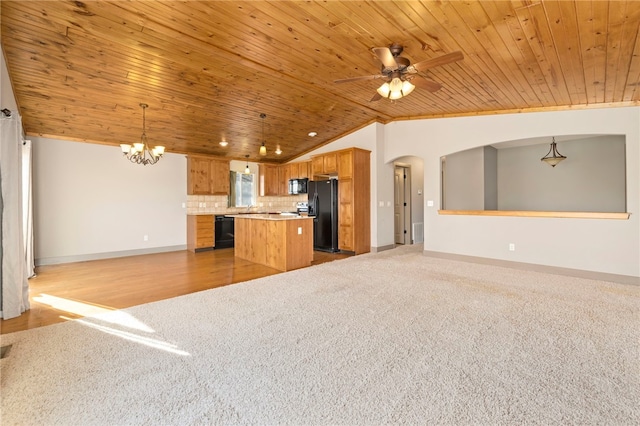 unfurnished living room featuring ceiling fan with notable chandelier, wooden ceiling, lofted ceiling, and light colored carpet