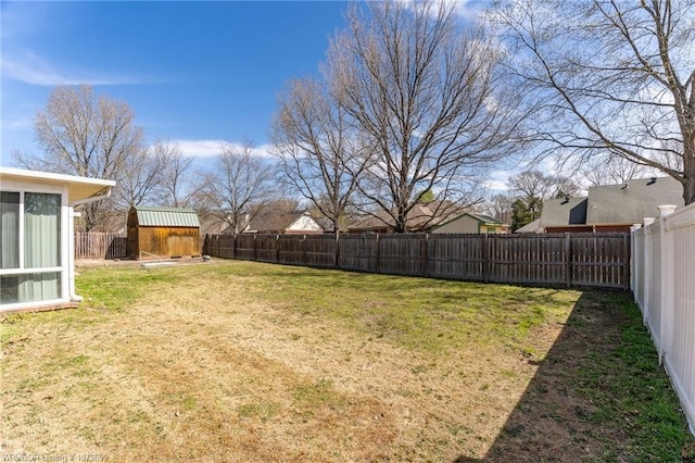 view of yard featuring an outdoor structure, a shed, and a fenced backyard