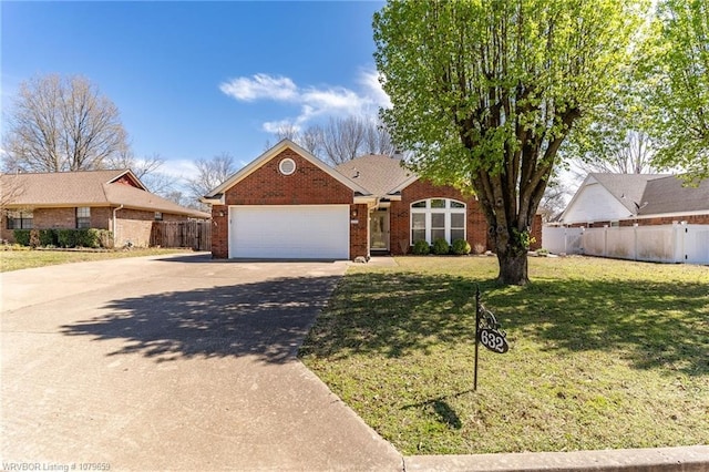 single story home featuring fence, a front lawn, an attached garage, driveway, and brick siding
