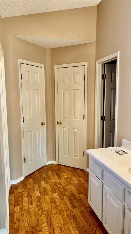 hall featuring baseboards and dark wood finished floors