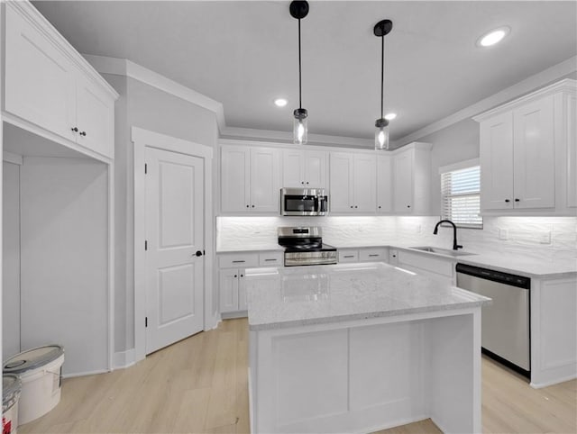 6 Osborne Ln, Bella Vista, AR 72715 - kitchen featuring appliances with stainless steel finishes, a sink, white cabinetry, light wood-style floors, and ornamental molding