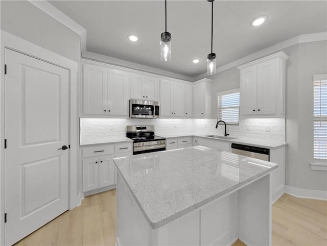 6 Osborne Ln, Bella Vista, AR 72715 - kitchen with appliances with stainless steel finishes, light wood-style floors, white cabinets, a sink, and recessed lighting