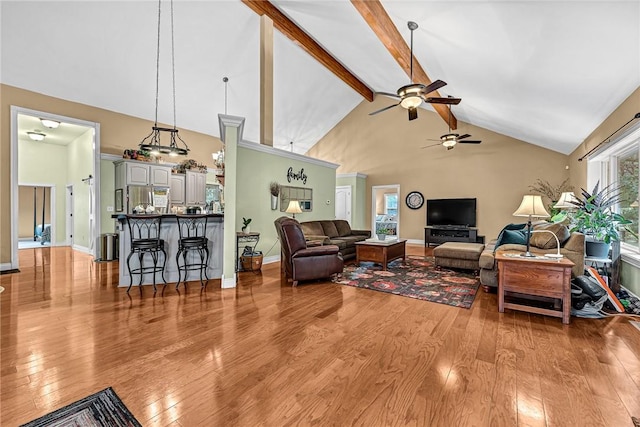 1401 Vickie Cir, Berryville, AR 72616 - living area featuring ceiling fan, light wood-style flooring, high vaulted ceiling, and beamed ceiling