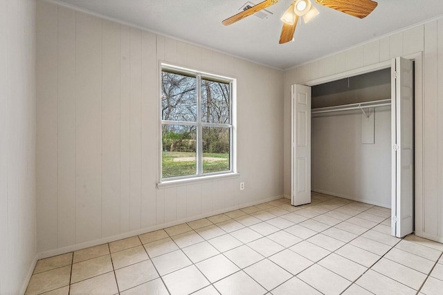 5694/925668/665644/42 W Michael Cole Dr, Fayetteville, AR 72704 - unfurnished bedroom with a ceiling fan, light tile patterned floors, crown molding, and a closet