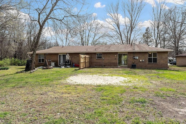 5694/925668/665644/42 W Michael Cole Dr, Fayetteville, AR 72704 - back of property featuring a lawn, brick siding, and cooling unit