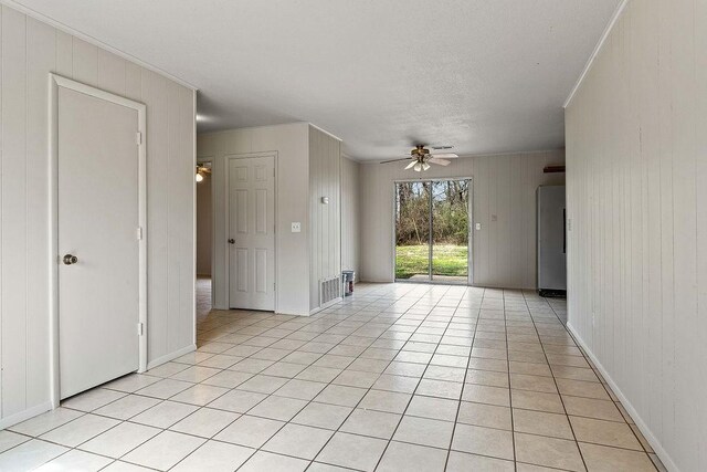 5694/925668/665644/42 W Michael Cole Dr, Fayetteville, AR 72704 - empty room featuring ornamental molding, baseboards, light tile patterned flooring, visible vents, and a ceiling fan