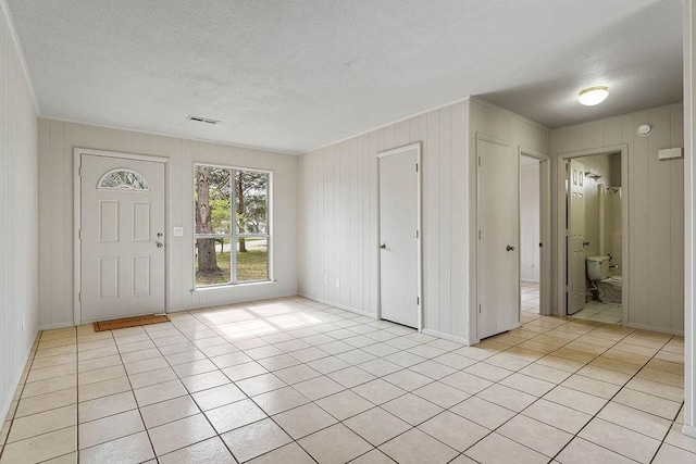 5694/925668/665644/42 W Michael Cole Dr, Fayetteville, AR 72704 - entrance foyer with light tile patterned flooring, visible vents, ornamental molding, and a textured ceiling