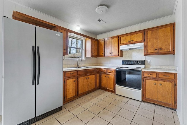 5694/925668/665644/42 W Michael Cole Dr, Fayetteville, AR 72704 - kitchen featuring visible vents, under cabinet range hood, a sink, freestanding refrigerator, and electric range