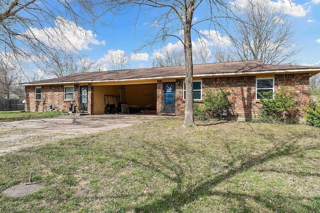 5694/925668/665644/42 W Michael Cole Dr, Fayetteville, AR 72704 - back of property featuring brick siding, an attached carport, driveway, and a lawn