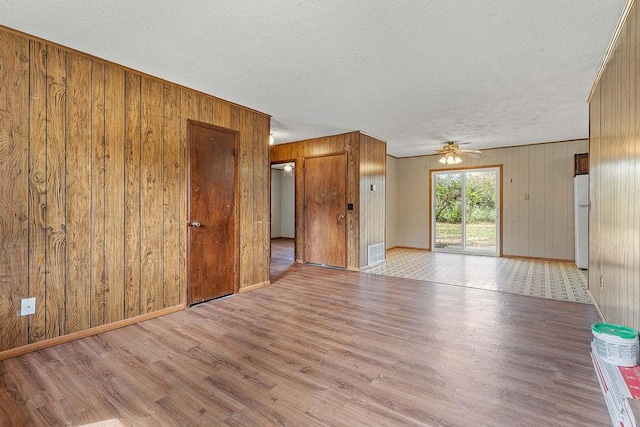 5694/925668/665644/42 W Michael Cole Dr, Fayetteville, AR 72704 - spare room with visible vents, a textured ceiling, wood finished floors, and a ceiling fan