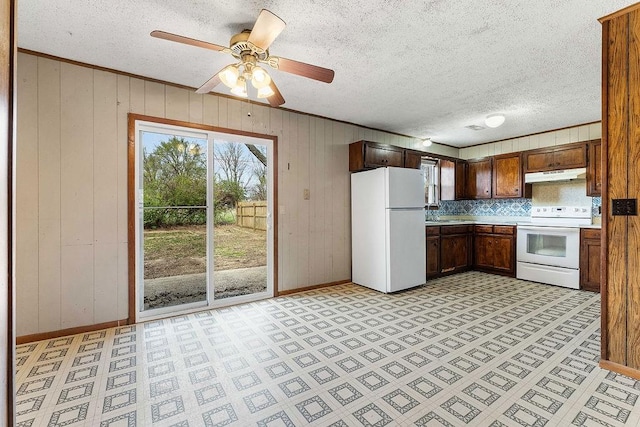 5694/925668/665644/42 W Michael Cole Dr, Fayetteville, AR 72704 - kitchen featuring light countertops, light floors, under cabinet range hood, white appliances, and ornamental molding