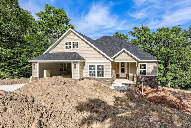 7 Boreray Ln, Bella Vista, AR 72715 - craftsman house with stone siding, covered porch, and roof with shingles