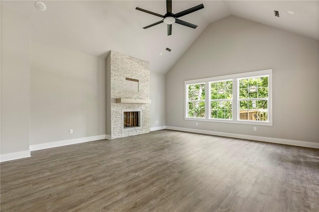 7 Boreray Ln, Bella Vista, AR 72715 - unfurnished living room with ceiling fan, wood finished floors, baseboards, high vaulted ceiling, and a fireplace