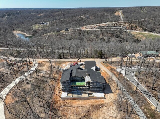 drone / aerial view with a wooded view