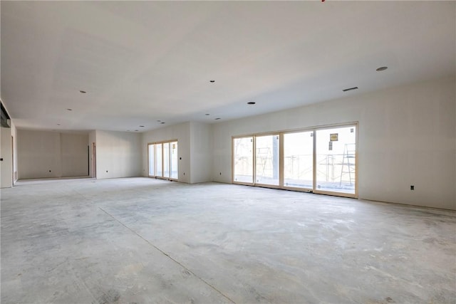 spare room with unfinished concrete floors