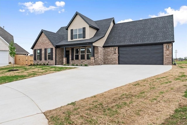 view of front facade with brick siding, driveway, a garage, and roof with shingles