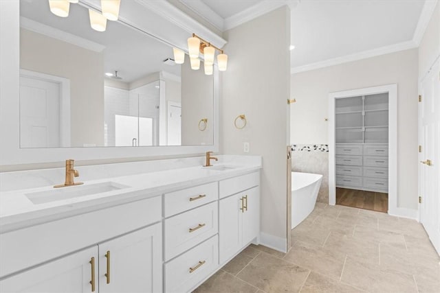 full bathroom with double vanity, a soaking tub, crown molding, and a sink