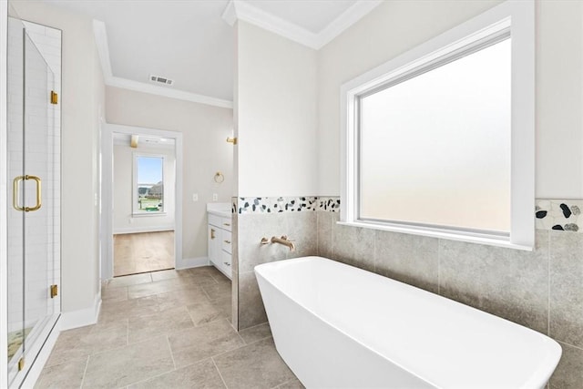 full bath featuring a shower stall, crown molding, vanity, a soaking tub, and visible vents