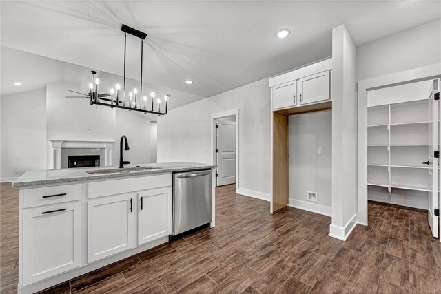 98 N Banner Ave, Farmington, AR 72730 - kitchen with stainless steel dishwasher, a sink, white cabinetry, open floor plan, and dark wood-type flooring