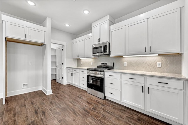 98 N Banner Ave, Farmington, AR 72730 - kitchen with stainless steel appliances, baseboards, white cabinets, and recessed lighting
