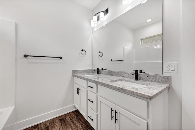 98 N Banner Ave, Farmington, AR 72730 - bathroom featuring double vanity, baseboards, and wood finished floors
