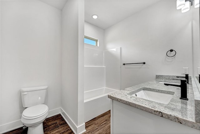 98 N Banner Ave, Farmington, AR 72730 - bathroom with double vanity, toilet, wood finished floors, baseboards, and shower / bathtub combination