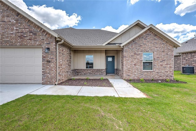 98 N Banner Ave, Farmington, AR 72730 - view of front of property with board and batten siding, central AC unit, brick siding, a front yard, and a garage
