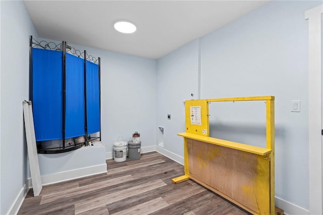 interior space with baseboards and wood finished floors