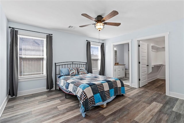 bedroom with baseboards, visible vents, and wood finished floors