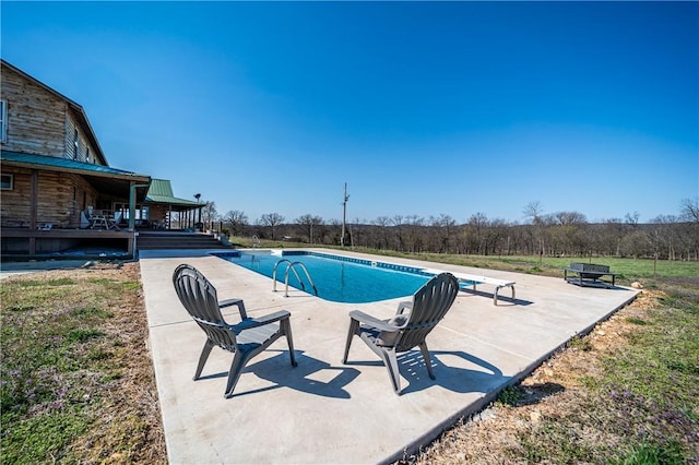 pool with a patio and a wooden deck