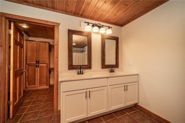 bathroom featuring double vanity, wooden ceiling, tile patterned flooring, and a sink