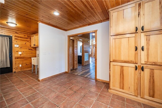 kitchen with tile patterned floors, wood ceiling, and light brown cabinets