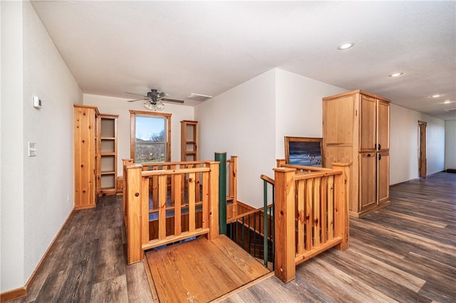 corridor with an upstairs landing, recessed lighting, dark wood-style flooring, baseboards, and visible vents