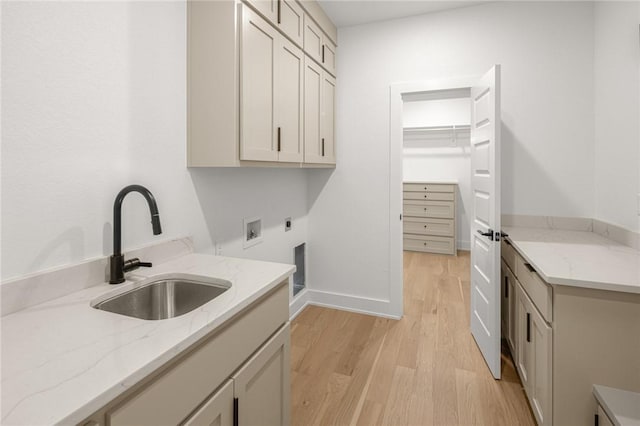 13040 Seba Rd, Centerton, AR 72719 - clothes washing area featuring light wood-type flooring, cabinet space, hookup for an electric dryer, washer hookup, and baseboards