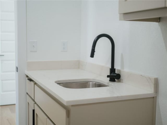 13040 Seba Rd, Centerton, AR 72719 - kitchen view of a sink, white cabinets, and light stone countertops