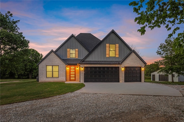 13040 Seba Rd, Centerton, AR 72719 - modern inspired farmhouse with concrete driveway, board and batten siding, brick siding, a yard, and a garage