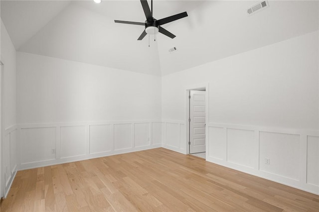 13040 Seba Rd, Centerton, AR 72719 - unfurnished room with a ceiling fan, high vaulted ceiling, light wood finished floors, a decorative wall, and wainscoting