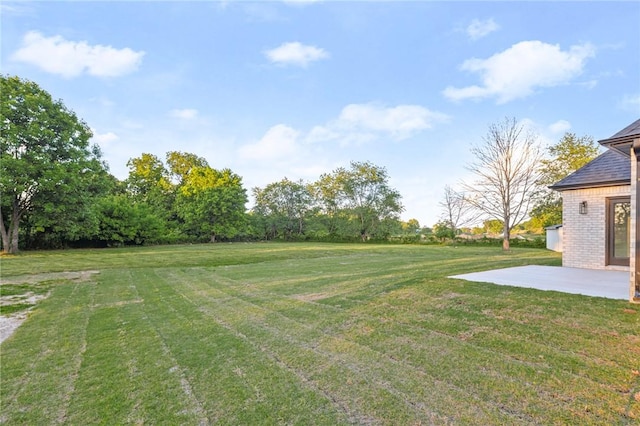 13040 Seba Rd, Centerton, AR 72719 - view of grassy yard featuring a patio area