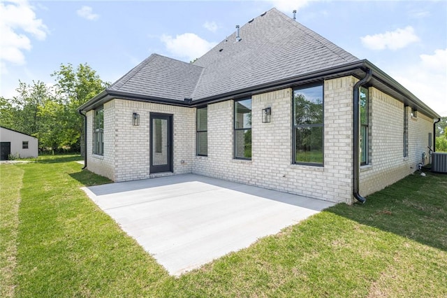 13040 Seba Rd, Centerton, AR 72719 - back of house with a shingled roof, a patio area, a lawn, central AC unit, and brick siding