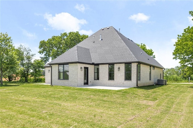 13040 Seba Rd, Centerton, AR 72719 - rear view of house featuring a patio area, central air condition unit, brick siding, and a lawn