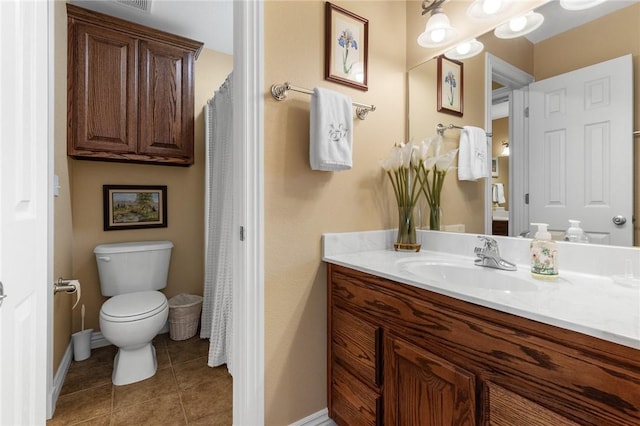 bathroom with tile patterned floors, vanity, toilet, and baseboards