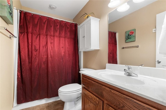 bathroom with tile patterned floors, vanity, and toilet