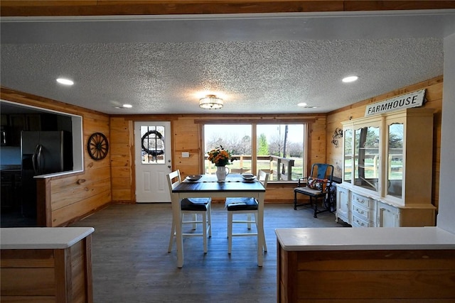 12766 Rocky Hill Rd, Prairie Grove, AR 72753 - dining room featuring recessed lighting, wood walls, dark wood-type flooring, and a textured ceiling